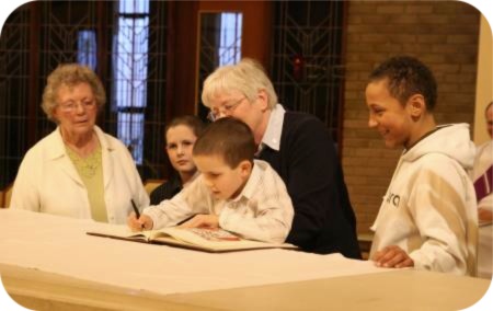 photo of youngsters signing the Book of the Elect