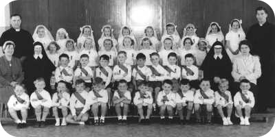 an old photo of pupils and staff at St Pius X Primary School