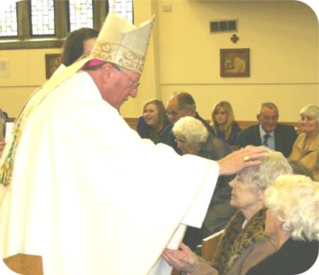 photo of Bishop Terry anointing Mrs Win Larvin