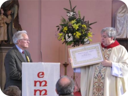 photo of Father Bill East presenting the citation