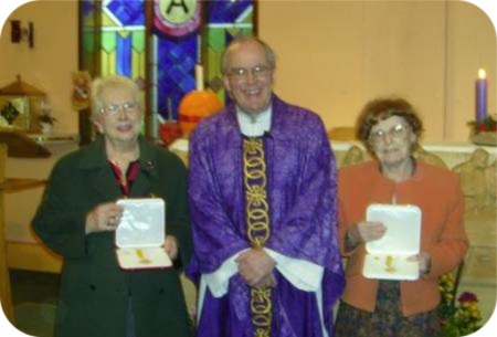 photo of two Holy Cross parishioners receiving honours