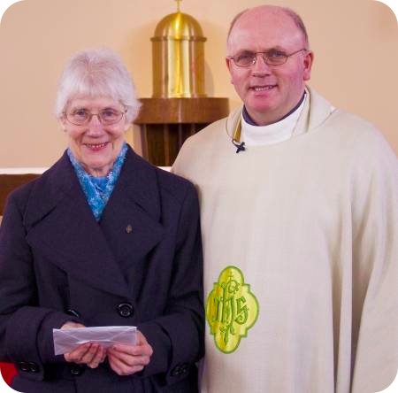 Photo by Paul Terry of Sister Cecilia Wilkinson receiving her gift from Canon Gubbins