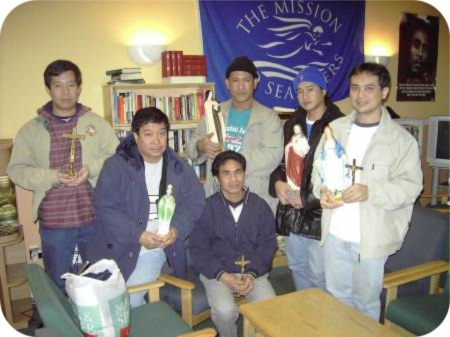 photo of seafarers with statues and religious items donated by a local parishioner