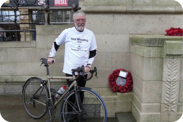 photo of David with his bike and a wreath at Hull Cenotaph