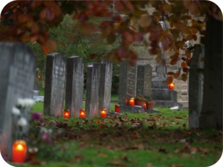 day-time photo of candles at graves in Ampleforth
