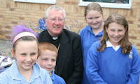 photo of Bishop Terry Drainey with some school children