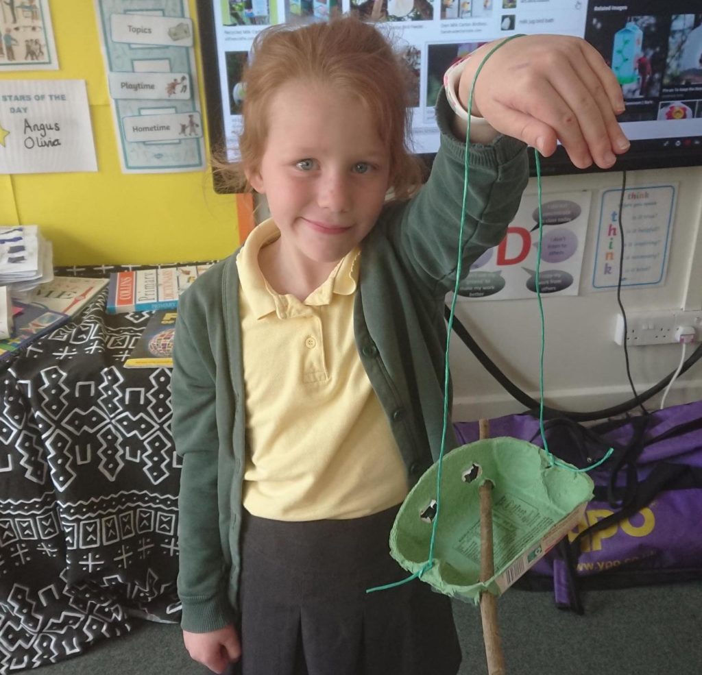 A Year 3 pupil at St John of Beverley with one of the bird feeders the school has placed around its grounds