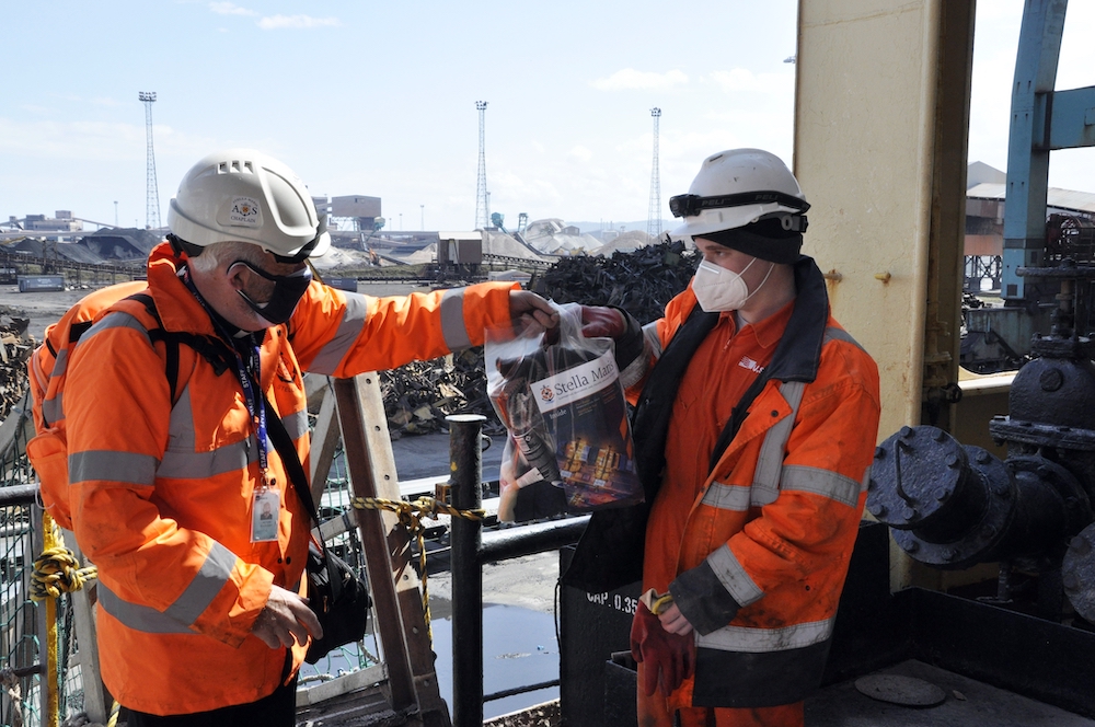 A Stella Maris chaplain hands over a care package to a seafarer