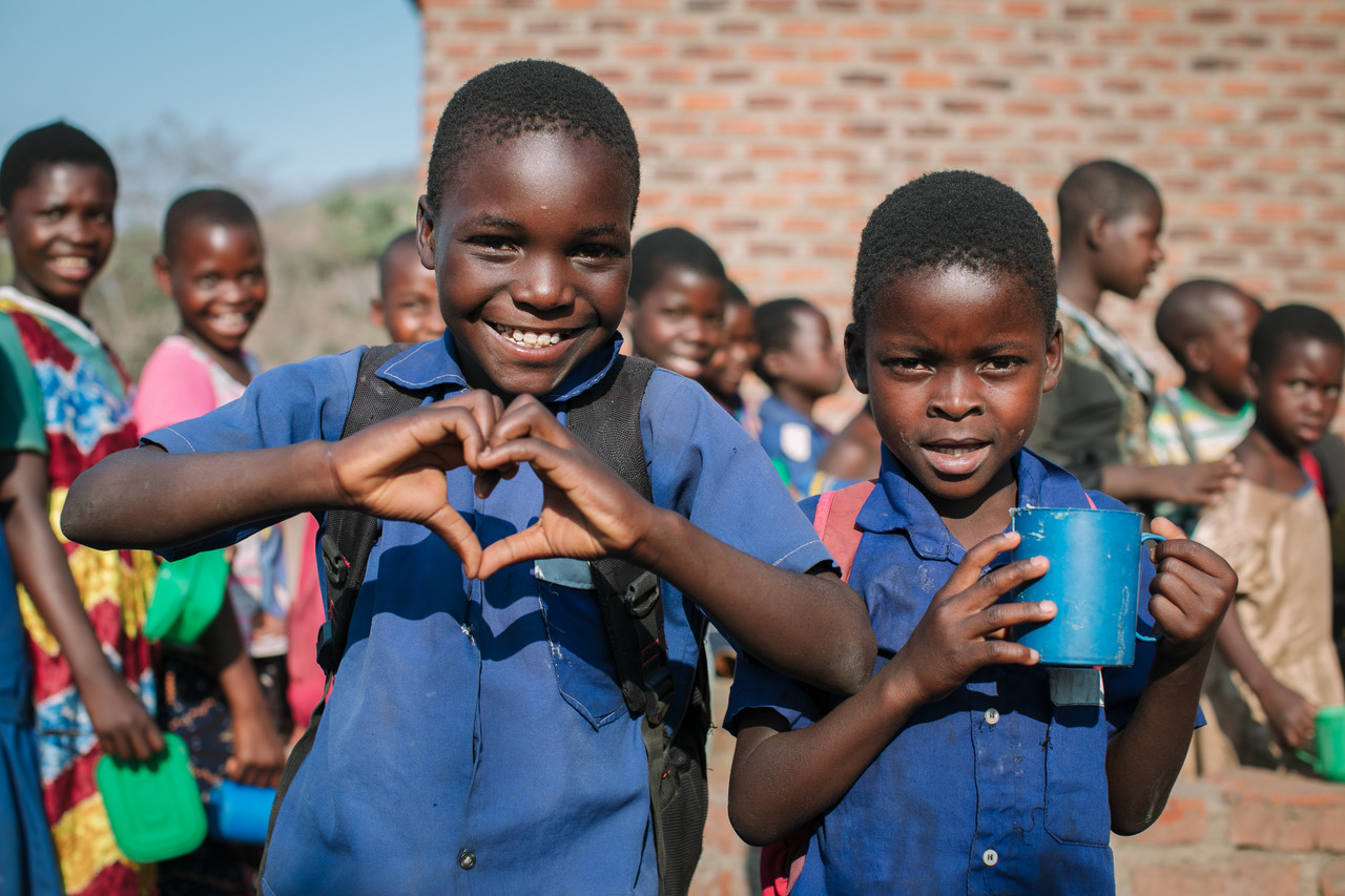 Children in Malawi receiving Mary’s Meals – Photo by Andrew Cawley