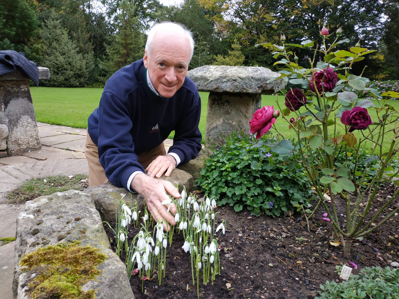 Mike Heagney with some of the early blossoming snowdrops at Tudor Croft Gardens